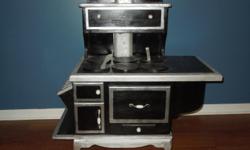 Old fashion wood stove. Stands roughly 42" tall, 33"wide and 19"deep. It has coal shutes, burner plates, ash drawers,warming doors and main oven. Made of pine and plywood.
&nbsp;
