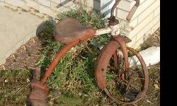 This is an old rusted tricycle that would look good as a lawn ornament.&nbsp; Mostly it is fun to look at.