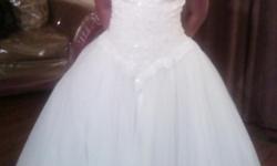 I bought the Oleg Cassini Wedding Gown last year in 2013 for my cotillion.I only wore the gown once and that was for the night of,since then I kept the gown preserved in bags out of harms way.The gown has no rips or spills,practically brand new.The size