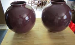 Nice pair of purple vases in great condition. No name or markings on bottom. Vases measure approximately 8 3/4 inches tall and 7 1/2 inches wide.