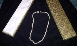 CULTURED PEARL NECKLACE IS 7MM IN DIAMETER WITH A TOTAL OF 69 PEARLS KNOTTED BETWEEN EACH PEARL.
22" TOTAL LENGTH OF NECKLACE WITH GOOD COLOR, QUALITY, AND LUSTRE.
STERLING CLASP WITH 1 CENTER 6MM PEARL.&nbsp;
8 - 2MM TRIM PEARLS AND DIAMONDS BETWEEN EACH