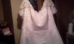 Beautiful David's Bridal wedding gown in size 22. Long train, sheer cap sleeves with delicate beading and lace throughout. Worn once, needs steamed, still have reciept .paid 599.99 originally. Has storage bag.included.
