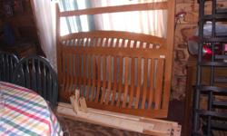 Queen size Sleigh Bed in almost new condition. No scratches or chips. This is solid oak, not press board. Pictures available upon request. Comes with side boards. There are also 3 bracing boards that go underneath the bed. This was purchased in 2006.
