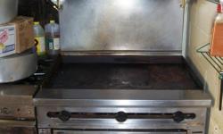 Wolf, 3 ft flat top w/ overhead broiler ( however needs new heat shield) and full size oven. Flat top or "griddle" and oven both work well. Natural gas.