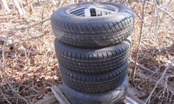 4 RIMS THAT CAME OFF A GRAND AM AND 3 ALMOST NEW TIRES. SIZE-185-75-14 .