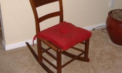 Rocking chair w/red cushion. In mint condition.