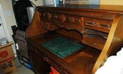 Beautiful Dark wood Rolltop desk w/green marble inlaid top. Breaks down to 5 pieces for easy moving. It has 8 drawers below desk top and 4 drawers above. Minor abrasions on desktop. Have more photos please ask if interested.