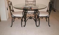 Moving must sell. Round Glass Dining Table with Wrought Iron Legs and 4 Matching Chairs. Like New. REDUCED. $150 or best offer. CASH ONLY. By Appointment only. Serious buyers should send telephone number and address will be provided. Once item is sold, ad