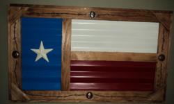 TEXAS FLAG MADE OF BARN TIN FRAMED IN CEDAR WOOD WITH FOUR 1 3/4 " STEER CONCHOS AND AND BARB WIRE ALONG THE BORDER WITH A 5 " STAR. APPROX. SIZE 35 " X 21 " X 1 1/2 ".