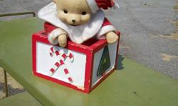 This red and white "Santa Bear" windup music Box measures 4 1/2" (square) X 7 1/2" with Christmas tree,candy cane,trumpet designs & wind-key on it's sides and gyrates clockwise while playing "it's a small world after all". Nice addition to the Christmas