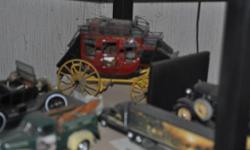 a collection of scale model cars, trucks, and stage coach. includes a budweiser christmas tractor and trailer,athomas kinkade tractor and trailer, aterry redkin tractor and trailer , aterry redkin gone fishing pickup, plus two all metal scale model cars a