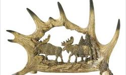 From the heart of a cleverly fashioned replica antler, an intrinctly carved panel depicts a moose and his mate as they traverse a tranquil forest glen. Inspired by the centuries-old carvings by the native forest tribes, this faux ivory tabletop plaque