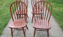 Set of four wooden kitchen table chairs in fantastic condition. Solid wood and a comfortable design.