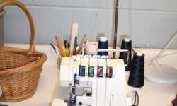 singer serger and over 100 thread cones / 1/3 are still in wrappers and 5 serger books