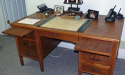 34" x 60" Six-drawer solid walnut desk. Has pull-out writing slides. Nice finish. All drawers are dovetailed.