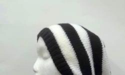 A slouch hat, oversized beanie knitted in black and white 1 Â½ stripes This slouch hat is a medium thickness, (not heavy) very stretchy, will fit any head, will stretch out to 31 inches around. Worn by men and women. Large size. The measurements are lying