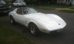 FOR SALE 1974 CORVETTE 4-spd, T-Top. The previous owner had a nice White clearcoat/basecoat paint job put on it
and has a great shine. The interior is light saddle leather. The frame/body and underside is very nice and not scaly anywhere, it's not a