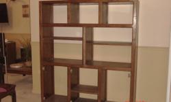 This is a solid oak bookcase (or entertainment consul) that is well put together...5'3"Wx6'Hx18" D
also has seven doors made of the same material..all stained the same...Dark Oak. This unit can be
either laid flat against the wall or go toward center of
