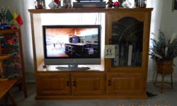 This is solid Oak Entertainment Center that is 6 Foot Tall and 4 Foot Wide. This entertainment center has a opening that will fit a 32 Inch Flat Screen with 2 Storage Cabinets under the section where the TV Sits which are 17.5 Inches wide with 2 Doors and