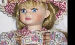Stitchin' Stacey is a Marie Osmond porcelain doll, third in the "Quilting Cousins" series. She is dressed in a country themed cotton dress with a matching hat. Stacey is blonde with blue eyes, and 11 inches tall. She is number 659 of 5000 and comes with a