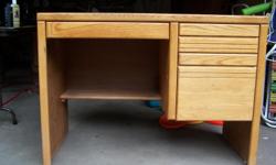 Oak student desk with three drawers including one file drawer. Has shelf underneath.&nbsp; Very good condition.