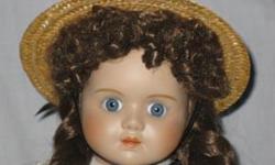 This is a Swiss porcelain doll I purchased in Switzerland. She is approximately 18 inches tall with brown hair and blue eyes. She wears a burgundy dress and comes with a straw hat and stand.
This doll is pre-owned in great condition and comes from a