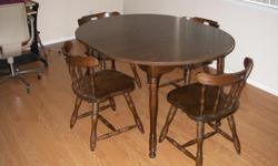 Walnut colored table with 1 leaf, and 4 captains chairs. Very good condition.