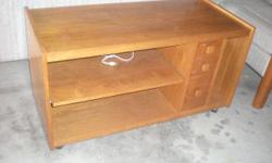 This piece has a slide out shelf below the table top which is suitable for components as well 3 small drawers. It measures 40" wide by 18" deep.