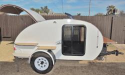 This is a small teardrop camper trailer; a sleeper with a rear galley, capable of being towed by many different vehicles with ease. It is perfect for one or two people who have tent camping equipment and want to have a more comfortable place to sleep
