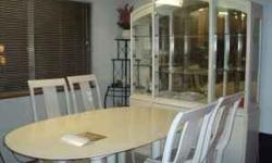 This is a nice, white Thomasville dining table set that includes an oval table that has an extra leaf that can extend the table in the middle, 6 chairs with 4 side chairs and 2 arm chairs, a china cabinet and a server table. The table just has minor wear