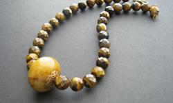 Gorgeous Beaded Semi Precious Tiger Eye Gemstone Necklace With A large Focal Jade Stone.
https://www.etsy.com/listing/84434200/brown-jade-tiger-eye-necklace-chunky?ref=shop_home_feat_4