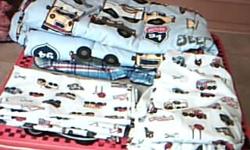 I have a toddler bedding set which includes: comforter, sheet, fitted sheet and pillow case. I bought it second hand but never used it. It has cars, trucks, etc on it. It is in great condition.