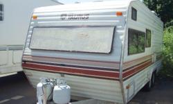 This is a 1984 Terry Taurus travel trailer. It is 24 feet long and has the basics of what you need. Bunks and the bathroom in back, dinette and kitchen in the center and a front bed/couch. The inside is nicer than the outside but for a 1984 unit this is