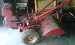 a full size electric start rotertiller, it also has pull start. self driven.
