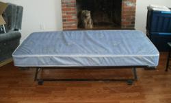 Folds down to roll under a day bed. Will spring up to normal height. comes with mattress , makes for a great extra bed.