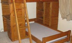 Pinewood Study Loft Bunk Bed set.
Set-up forms a T shape with one twin on top and the other twin centered below.
Lower twin bed frame is on casters for ease of pulling out.
Desk with three drawer storage and bulletin board on one end.
Five drawers with