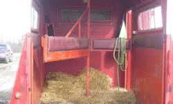this horse trailer is an 83 model , straight load with a drop ramp , it has a little four ft. dressing room , and for its age it is in good condition, it is very roomy for the horses , has mats on the floor , and two saddle racks and a bench in the