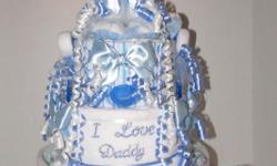 &nbsp;
Ty baby puppy pink 3 tier diaper cake baby shower gift centerpiece&nbsp;
&nbsp;
Cake Contains:
60-65 size 1 pampers diapers
2&nbsp;receiving&nbsp;blankets
1 fleece blanket
1 bib says "I Love Daddy"
2 wash cloths
1 pair of socks
1 onsie
1 bottle
2