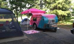 This is a "one of a kind" camper that is fun to camp in! It is approx. 6'x 12' and light weight. My 1/2 ton truck pulls it very easily. A small truck or car would have no problem going anywhere. It sleeps 2 adults, and you could add some little ones on