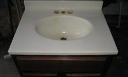 Vanity and Sink
25 inches Wide
19 inches Deep
31 inches High
Cultured marble Sink with Dark wood Vanity, Good Condition!