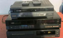 This lot includes three VCRs! &nbsp;The first is a Samsung with auto-tracking (model VP2503), the second is a Sharp with a wireless remote (model VC 7843U), and the third is also a Sharp with a remote (model VC A5230U). &nbsp;And while you're at it, get
