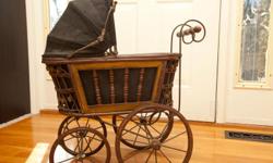 Victorian Doll buggy, carriage pram
Vintage Rattan wicker wood and black canvas vintage baby buggy for dolls.
This victorian style pram is made of beautiful rattan wicker wood and black canvas. The black canvas has a few small tears.
The canvas hood