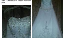 I have a beautiful wedding dress size 12. The dress retails for $1,100.00 I am asking $300. Dress has a long train in the back. Please call or text at 205-602-6778