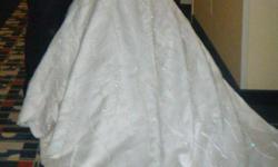 Beautiful ivory wedding dress with lots of pearls, detailed beading and a long train.&nbsp;
Worn once, cleaned and professionally hand-washed due to delicate crystals and beading. In excellent condition.&nbsp;
Comes with veil, unique hand-made bouquet and