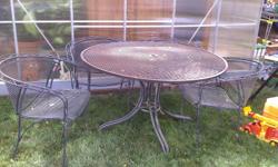 Wrought Iron patio set including table and 4 chairs. A set that will last a lifetime. $250.00 OBO