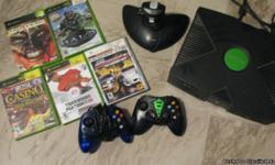 xbox gaming system complete with 1 wireless remote, 1 regular remote, 1 jotstick, and 5 games. Games include: Tao Feng-Fist of the Lotus, Halo-combat evolved,Midnight Club-DUB edition remix, Bicycle Casino includes Texas Hold'em, and Tiger Woods PGA tour.